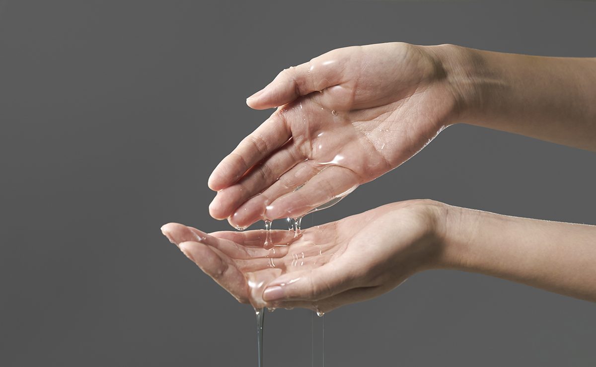 Clear watery texture running through two hands